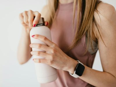 Close up of a water bottle and a fitness tracker