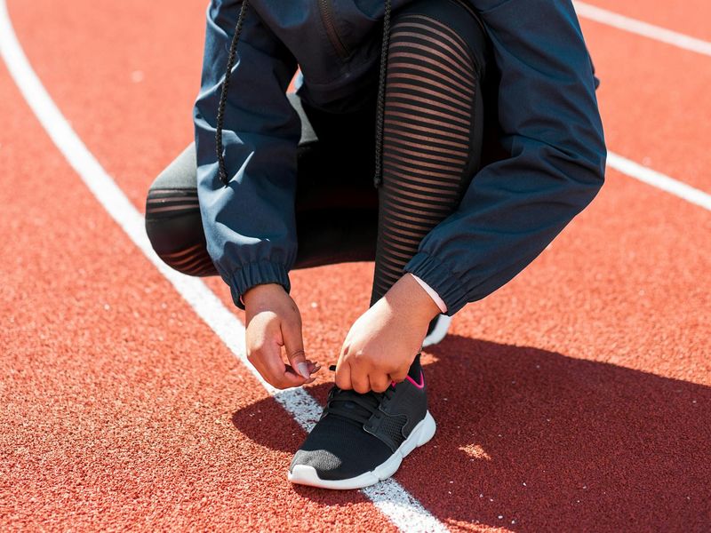 Detail of sports shoes on a running track surface
