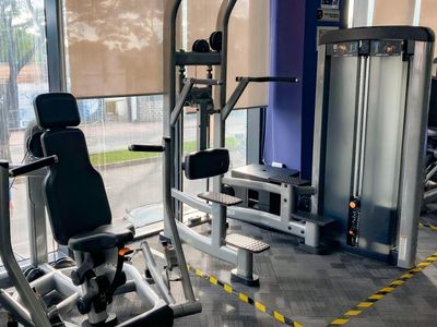 Sunlight streaming through large windows in a fitness studio